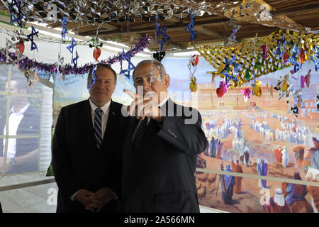 Jerusalem, Israel. 18th Oct, 2019. U. S. Secretary of State Mike Pompeo, left, and Benjamin Netanyahu speak at a sukkah, a traditional shack built for the weeklong Jewish holiday of Sukkot, at the Prime Minister's residence in Jerusalem on Friday, October 18, 2019. Pool Photo by Sebastian Scheiner/UPI Credit: UPI/Alamy Live News Stock Photo