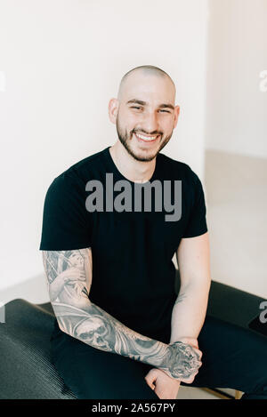 Portrait of young man with tattoo in studio Stock Photo