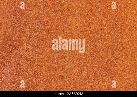 Flecked old rusty metal surface yellow-orange color. Close up macro view of pattern texture or background taken in natural environment Stock Photo
