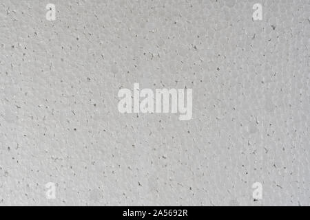 White abstract polystyrene foam background texture. Close-up detail view of styrofoam plastic sheet, polystyrene abstract synthetic packaging material Stock Photo