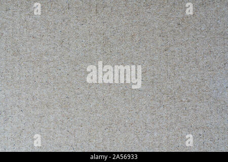 Light brown background from sheet of recycled cardboard. Closeup detail view of abstract texture recycled eco-friendly material pattern background Stock Photo