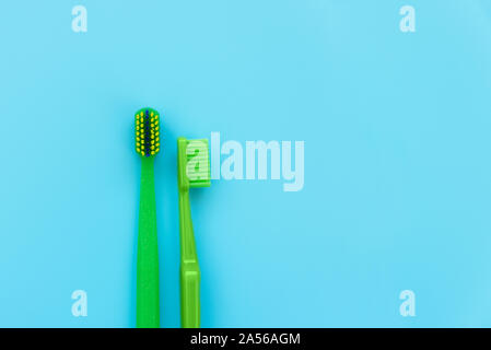 Original and orthodontic tooth brushes on blue background. Healthy lifestyle. Flat lay. Top view Stock Photo