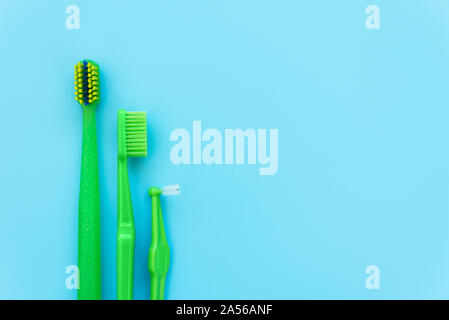 Original, orthodontic, angle interdental tooth brushes on blue background. Healthy lifestyle. Flat lay. Top view Stock Photo