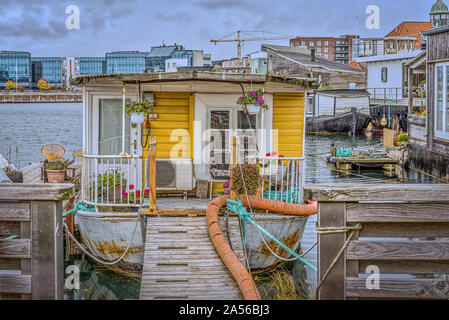 Gangway to a romantic houseboat with flowers on the porch in the South Habour of Copenhagen, October 12, 2019 Stock Photo