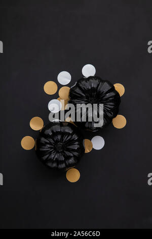 Black halloween lay flat composition with black pumpkins Stock Photo