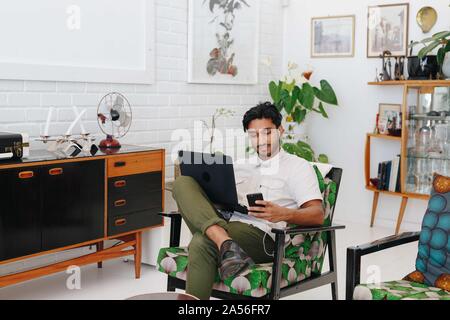 Businessman using laptop in office Stock Photo