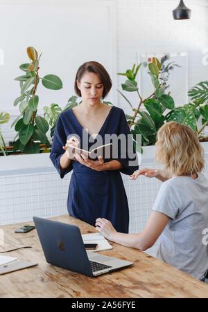 Colleagues having discussion in office Stock Photo