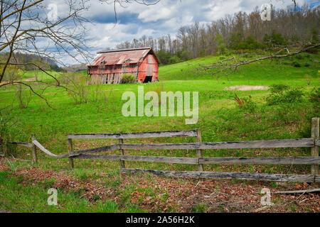Old Kentucky barn with fence in the foreground. Stock Photo