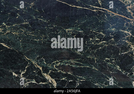 Black Marble background with white veins running through the smooth rock surface. Stock Photo