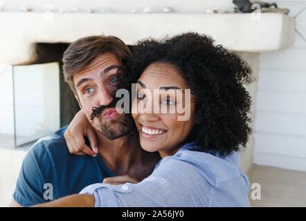 Couple taking selfie in beach house Stock Photo