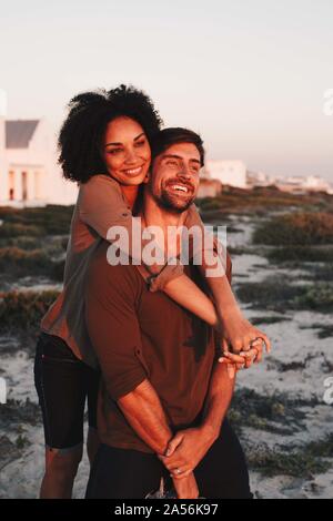 Couple enjoying view of sunset on beach Stock Photo