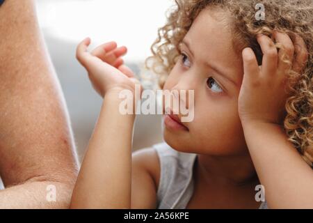 Girl listening attentively to adult Stock Photo