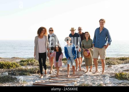 Family of eight taking walk on beach
