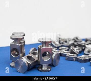 small machined parts manufacturing process ; tapping ; industrial background Stock Photo