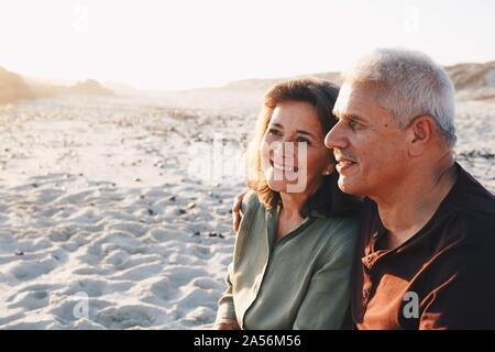 Senior couple enjoying sun on sandy beach Stock Photo