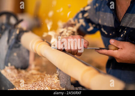 Carpenter working on wood to carving and shaping. Stock Photo