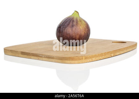 One whole sweet purple fig on bamboo cutting board isolated on white background Stock Photo
