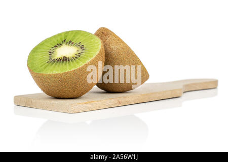 Group of two halves of exotic brown kiwi on wooden cutting board isolated on white background Stock Photo