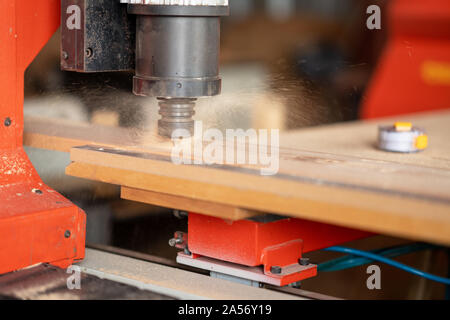 CNC Lathe machine working on wood to lathe and shaping. Stock Photo