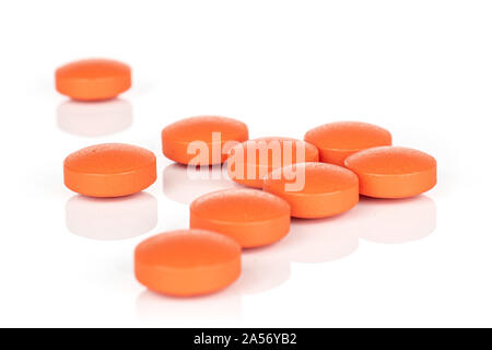 Group of nine whole orange tablet pharmacy isolated on white background Stock Photo