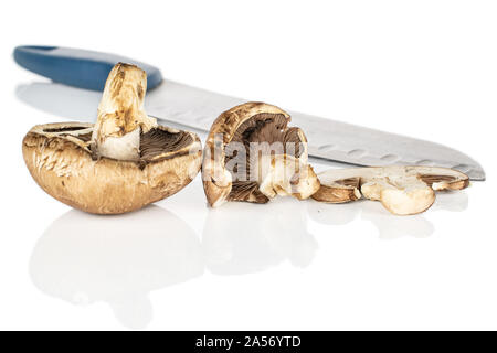 Group of two whole one slice of fresh brown mushroom champignon with steel knife isolated on white background Stock Photo