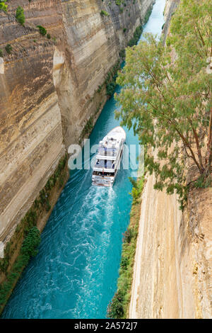 GREECE CORINTH - JULY 17 2019; Large pleasure boat passing through Corinth Canal with its deep sheer sides connecting the Gulf of Corinth with Saronic Stock Photo