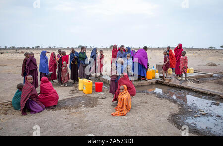 Arusha, Tanzania, 8th September 2019: maasai women at a well to fetch water. In this village goverment has provided a pump to get clean water from the Stock Photo