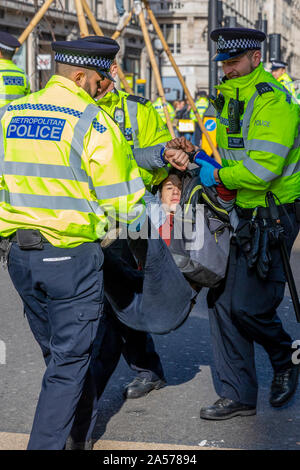 London, UK. 18th Oct 2019. Extinction Rebellion demonstrator is arrested at Oxford Circus, Oxford Street, London Credit: Ricci Fothergill/Alamy Live News Stock Photo