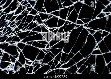 Close up of cracked glass surface. Broken glass tablet computer. Cracked screen. Stock Photo
