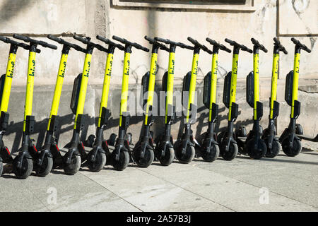 electric kick scooters from scooter-sharing system parked on a sidewalk in Warsaw, Poland Stock Photo