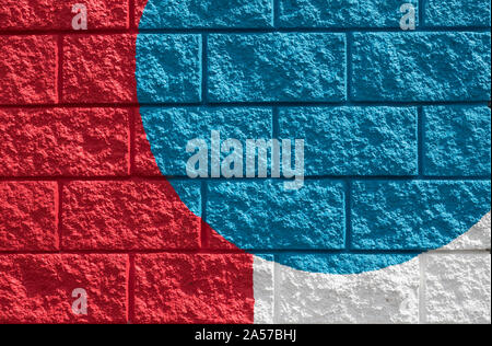 Close up on Colourfully painted red, white and blue brick wall Stock Photo