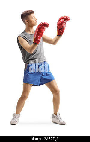 Full length shot of a young guy exercising with boxing gloves isolated on white background Stock Photo