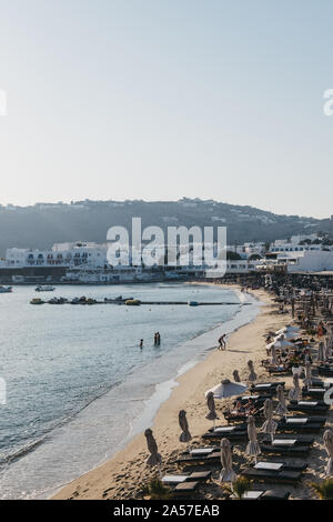 Mykonos, Greece - September 19, 2019: Rows of sunbeds on Platis Gialos beach, a popular beach on the south coast of Mykonos. Stock Photo