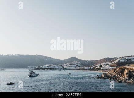 Mykonos, Greece - September 19, 2019: Yacht and boats heading towards Platis Gialos, a popular area and beach on the south coast of Mykonos. Stock Photo