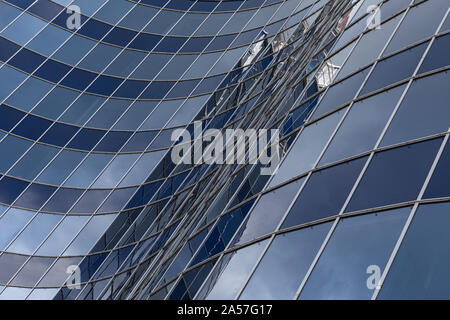 Waved facade of modern glass building of business centre in downtown Stock Photo