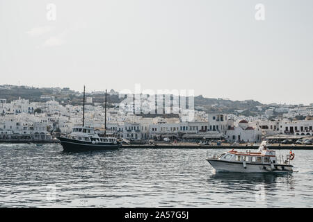 Mykonos Town, Greece - September 20, 2019: Boats moored in water by new port in Hora, also known as Mykonos Town, capital of the island and one of the Stock Photo