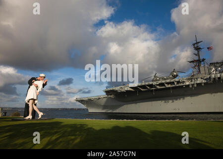 Sculpture Unconditional Surrender with USS Midway aircraft carrier, San Diego, California, USA Stock Photo