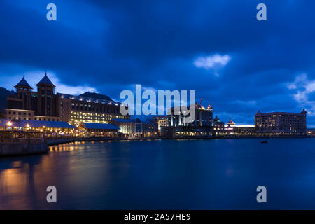 Buildings at the waterfront lit up at dusk, Caudan Waterfront, Port Louis, Mauritius Stock Photo