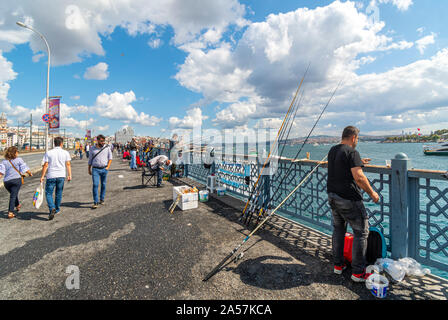 Local Turkish fishermen hang their fishing poles off the Galata Bridge over the Bosphorus at the Golden Horn. Stock Photo