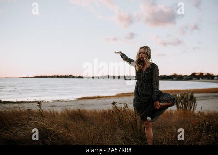 woman doing tree pose on the beach Stock Photo