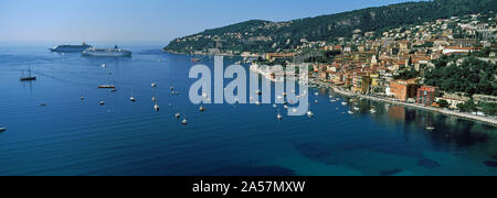 Houses in a town on a hill, Villefranche-Sur-Mer, Alpes-Maritimes, Provence-Alpes-Cote d'Azur, France Stock Photo
