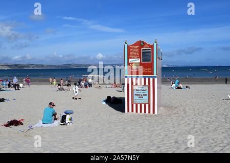 Punch and Judy Show on Weymouth Beach, Dorset UK on a sunny afternoon. Stock Photo