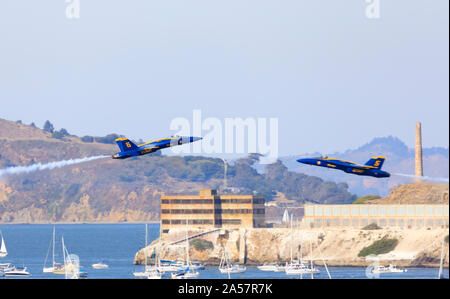 F/A-18 Hornet fighters of the United States Navy Flight Demonstration Squadron, The Blue Angels, perform over Alcatraz, San Francisco, California, US Stock Photo