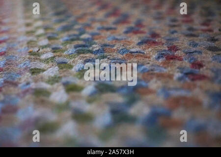 Close up image of a roughly tied seventies multicoloured textured carpet Stock Photo