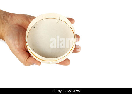 A hand holds a plate of birch bark on a white background. Isolate. Stock Photo
