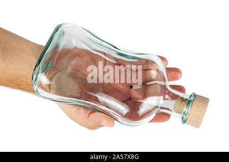 Hand holds an empty bottle with a cork. Stock Photo