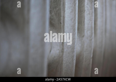 Close-up background image of an old painted cast iron radiator, shot wtith a narrow field of focus and with blurring in foreground or background Stock Photo