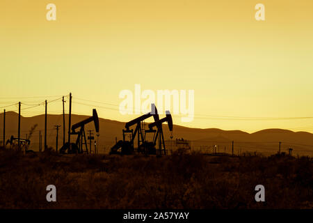 Silhouette of oil rigs at sunset, California, USA Stock Photo