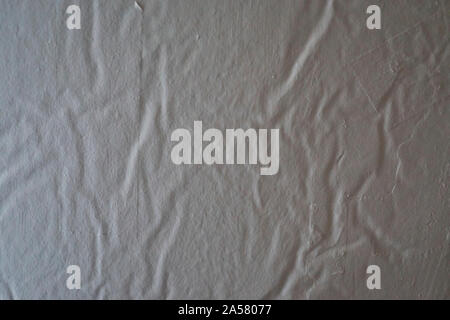 Backround image showing the texture on a painted wall where the wallpaper is waarped and textured Stock Photo