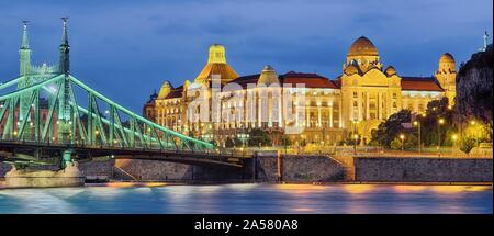 Gellertbad with Freedom Bridge illuminated, dusk, Budapest, Hungary Stock Photo